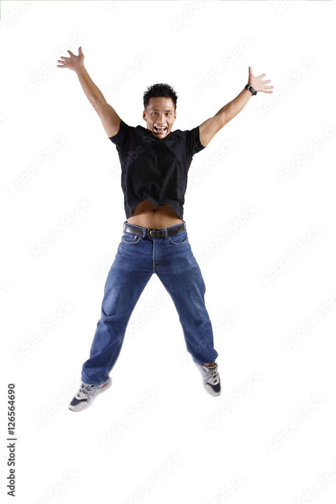 Young man with arms and legs outstretched